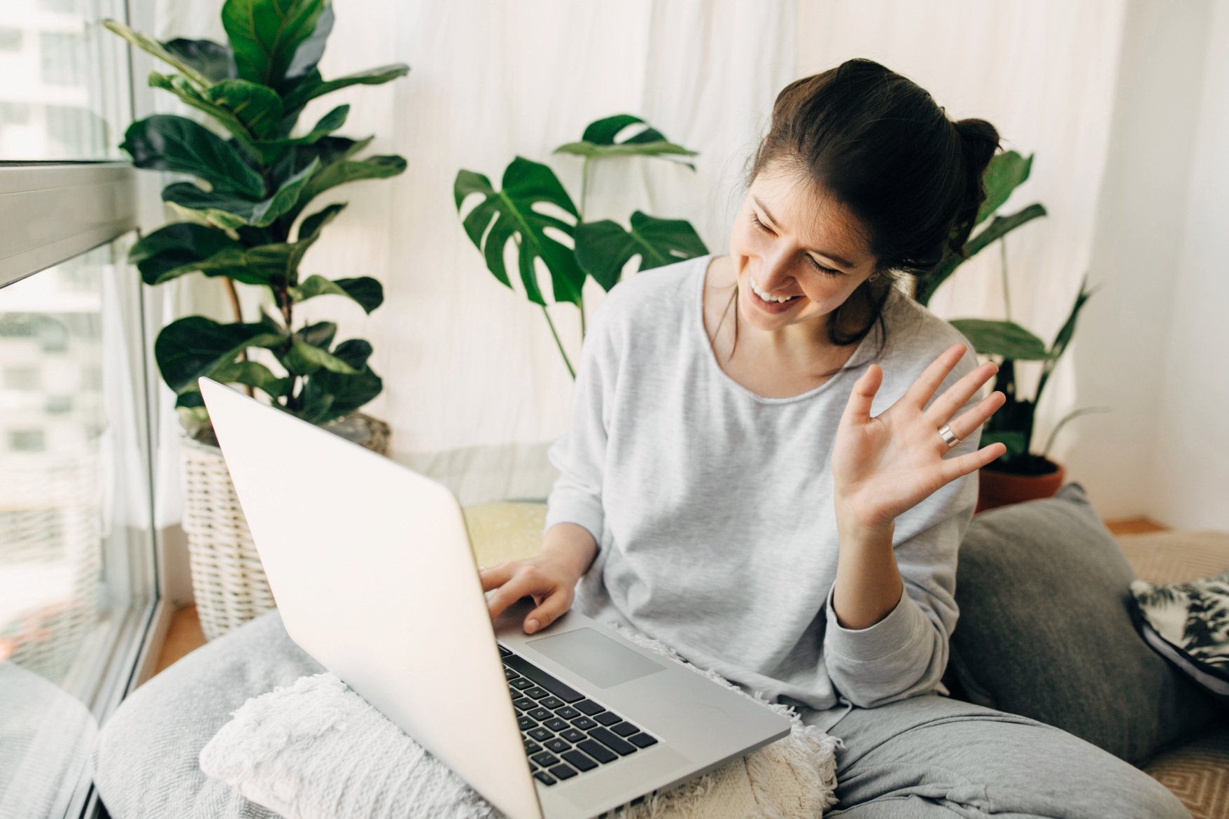 Happy Girl Waving Hi to Laptop, Video Chatting with Family or Fr